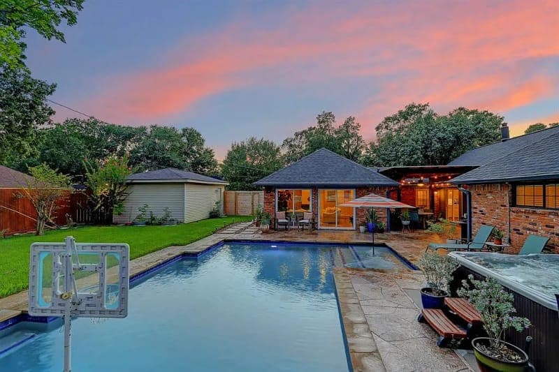 Houston backyard pool and cool deck patio at dusk