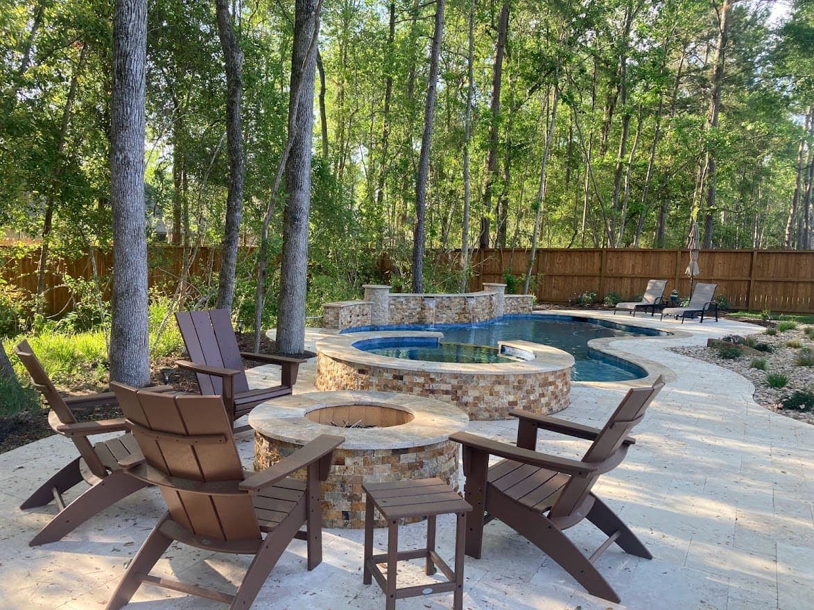 Pool with raised spa, waterfall, and fire pit seating area
