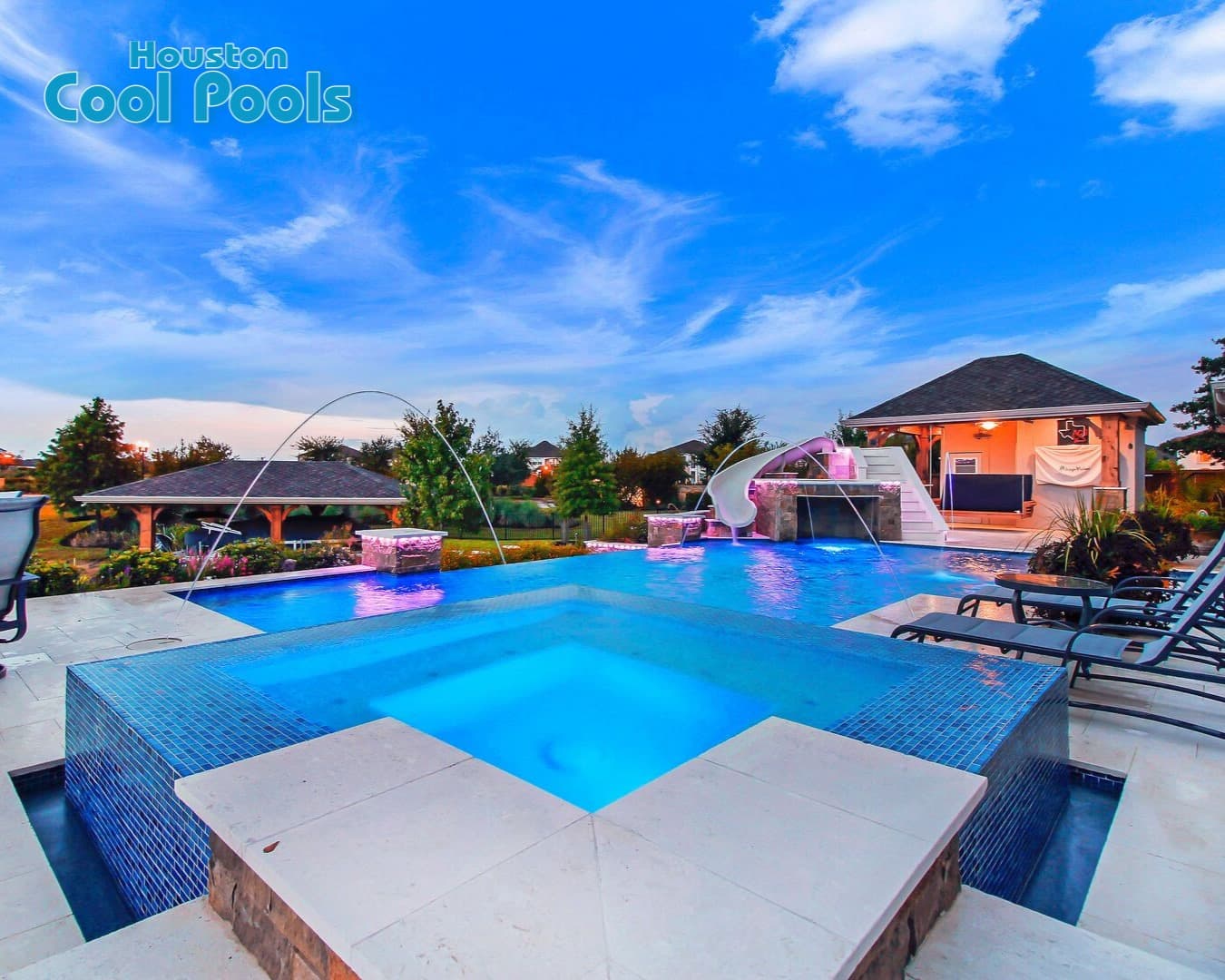 Backyard pool with deck jets, slide, and tanning ledge