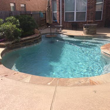 Free form pool by Houston Cool Pools - kidney-shaped pool with tanning ledge