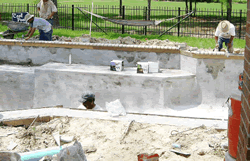 Bullnose brick coping installed along the top edge of the pool bond beam