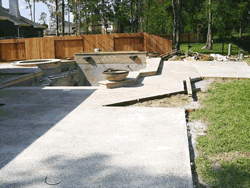 Boulders and rock waterfall installed around the pool perimeter