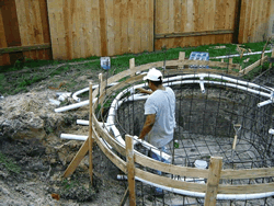 Schedule 40 PVC plumbing and electrical stub-outs run through the pool rebar cage