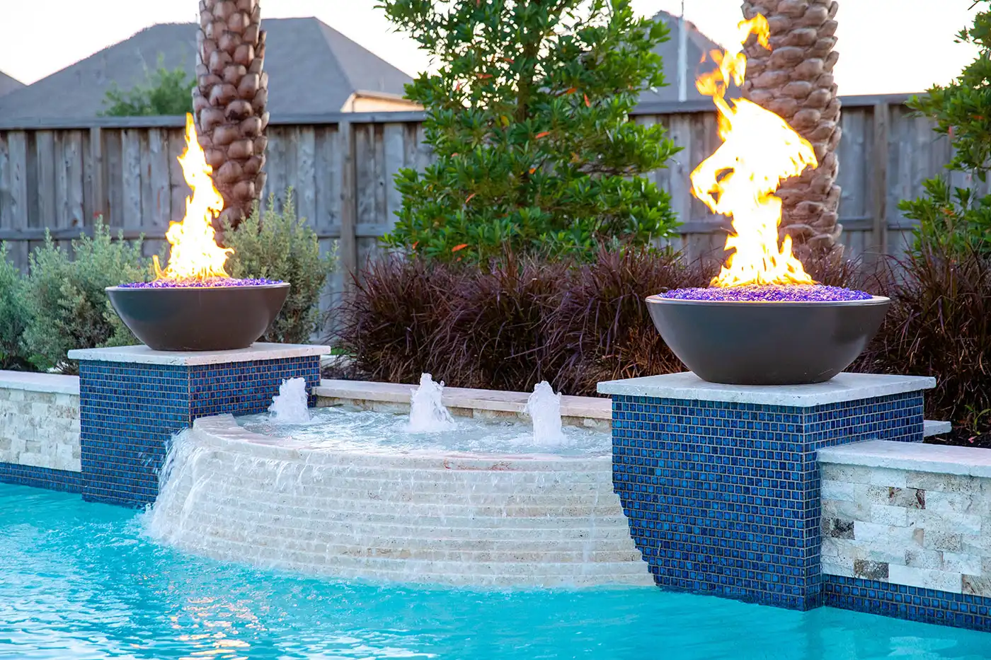 Fire bowls by Houston Cool Pools - twin fire bowls on tiled columns