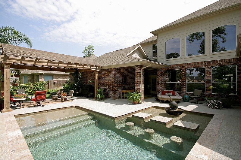 Geometric pool by Houston Cool Pools - rectangular pool with stone steps and tanning ledge