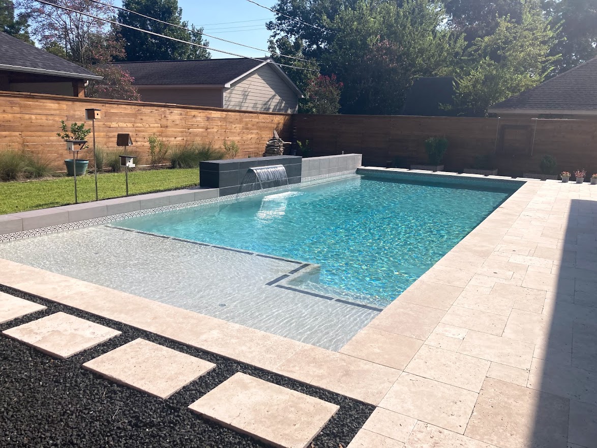 Geometric pool by Houston Cool Pools - rectangular pool with stacked-stone waterfall wall