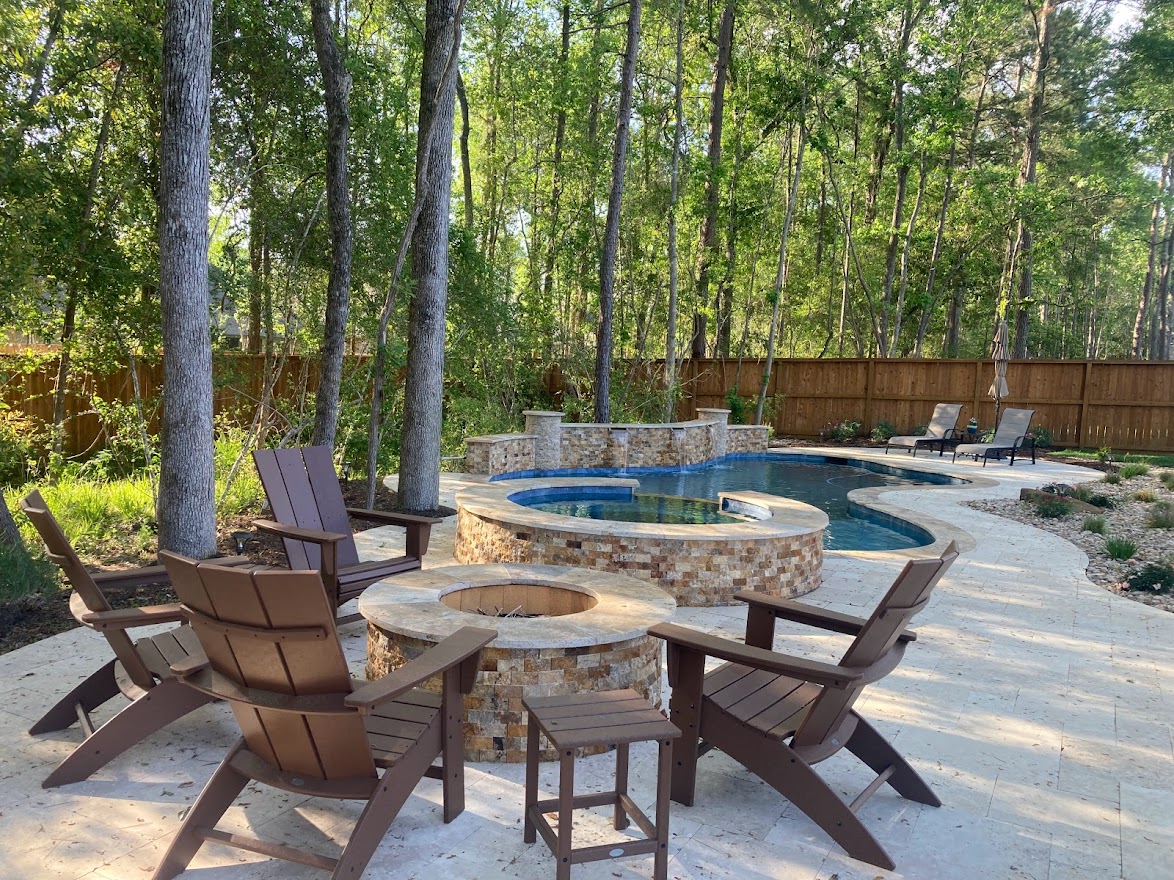Free form pool by Houston Cool Pools - curved pool with raised spa and fire bowls
