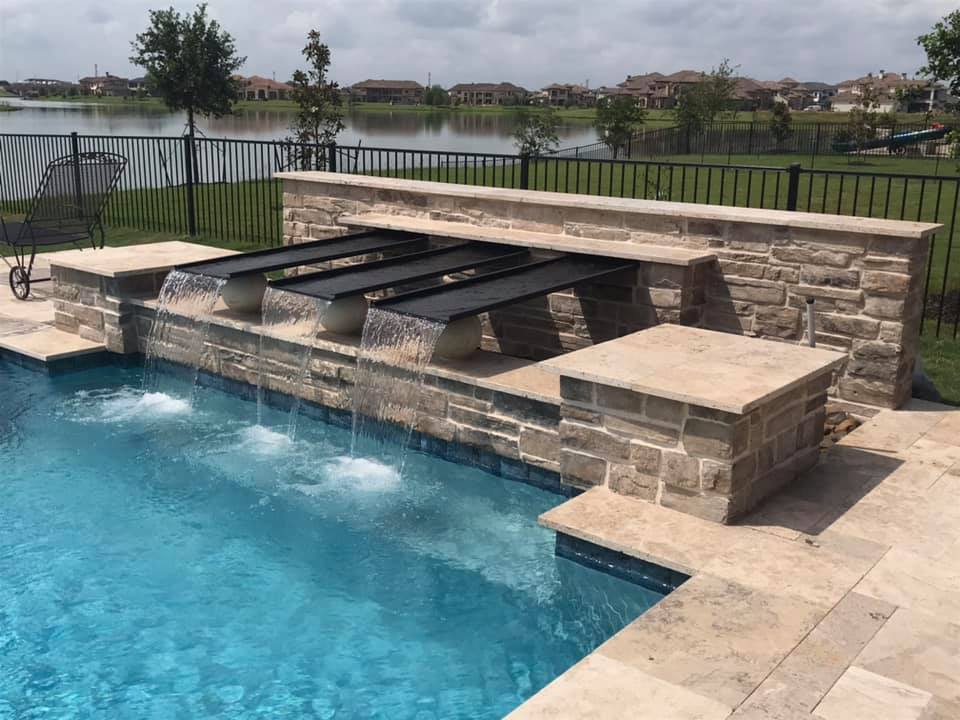 Water feature by Houston Cool Pools - stacked-stone spillway wall