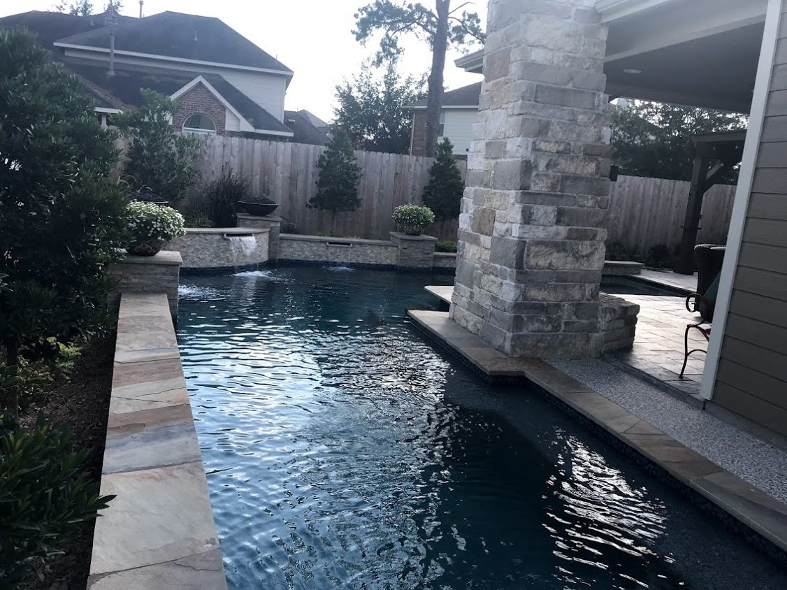 Fireplace and firepit by Houston Cool Pools - fire features at sunset