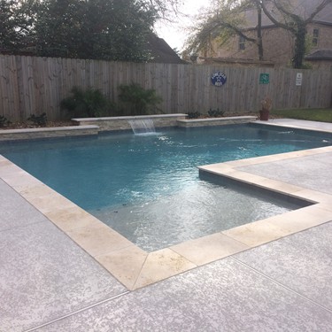 Geometric pool by Houston Cool Pools - rectangular pool with tanning ledge and sheer waterfall